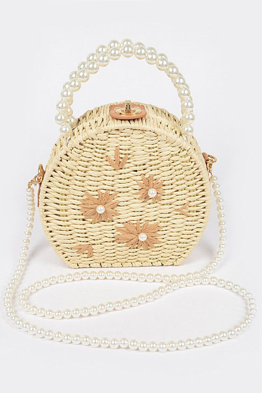 Beige straw handbag with pearl accents and pearl straps