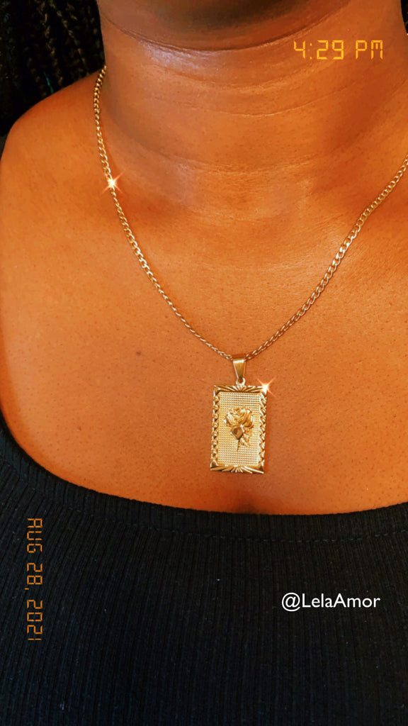 Model wearing gold rose pendant necklace